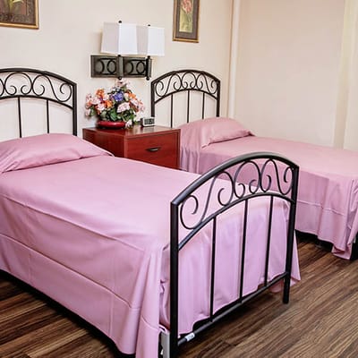 Cozy twin bedroom with floral decor and soft linens