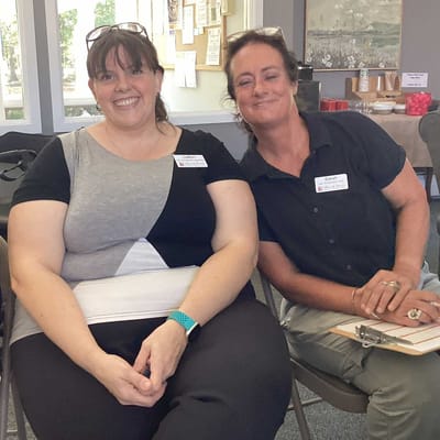 Staff members smiling in a common area