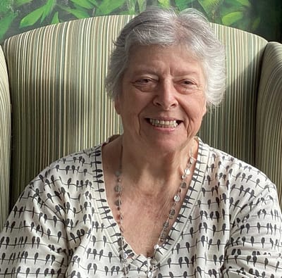 Smiling resident sitting in a cozy armchair