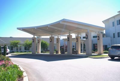 Entrance of a senior living facility with a covered driveway