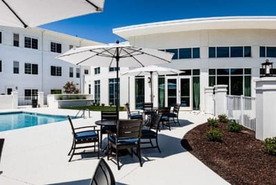 Outdoor pool area with seating and umbrellas