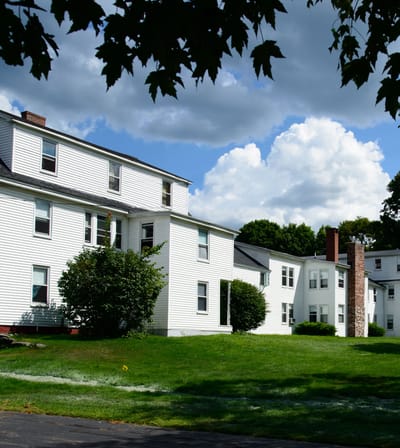 Exterior view of the assisted living facility surrounded by grass