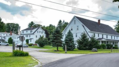 Exterior view of a senior living facility with trees