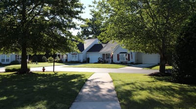 Exterior view of a senior living facility surrounded by trees