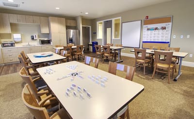 Interior common area with tables and kitchen accessibility