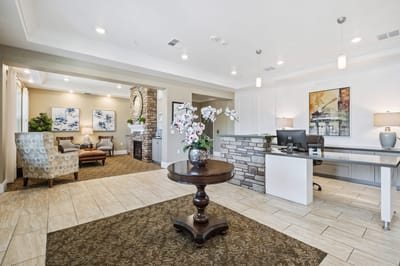 Well-decorated common area featuring seating and a reception desk