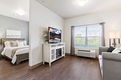 Cozy resident room with bed and TV