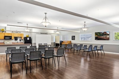Bright common area with chairs and piano