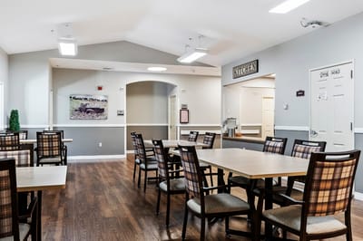 Dining area with tables and chairs in an assisted living facility