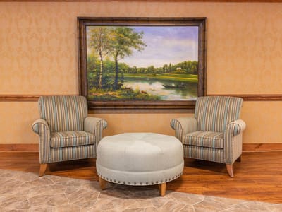 Comfortable seating area with artwork in the background