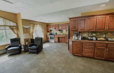 Bright common area with a kitchenette and seating