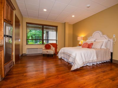Cozy resident room with a bed and window.