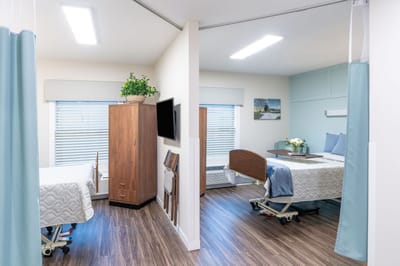 Bright shared resident room with medical beds
