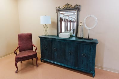 Interior decor of a common area with a chair and cabinet
