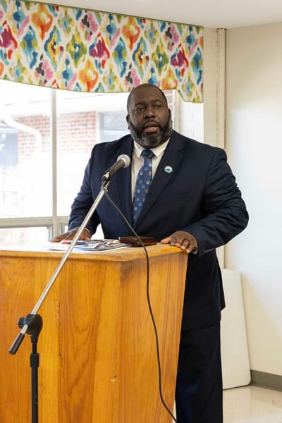 Speaker at a podium in a community gathering