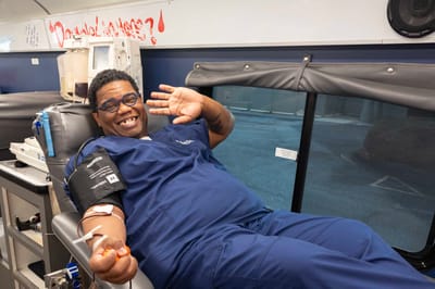 Happy medical staff member giving a thumbs-up