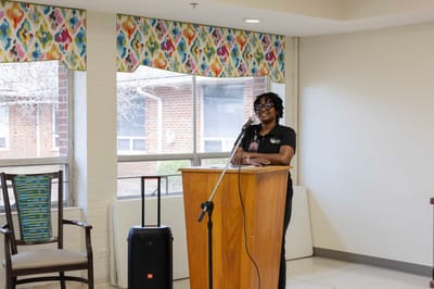 Staff member speaking at an indoor event