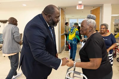 Residents interacting with staff in a common area
