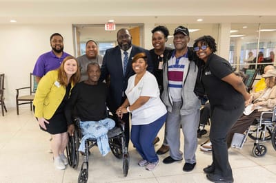 Group of residents and staff posing in the common area