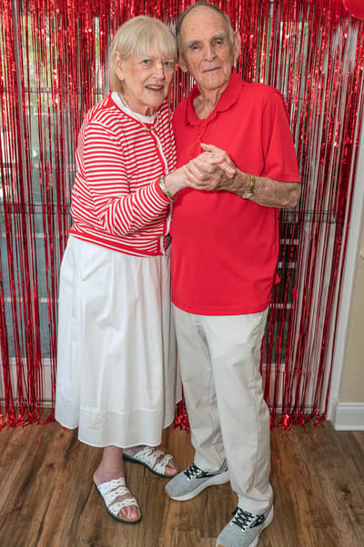 Residents dancing together in a lively common area
