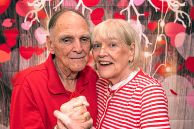 Senior couple dancing together in a decorated space