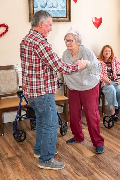 Residents dancing in a warm indoor activity area