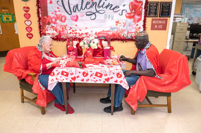 Residents celebrating Valentine's Day at a decorated table
