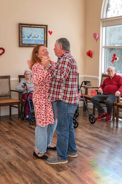 Residents dancing in a common area during an event
