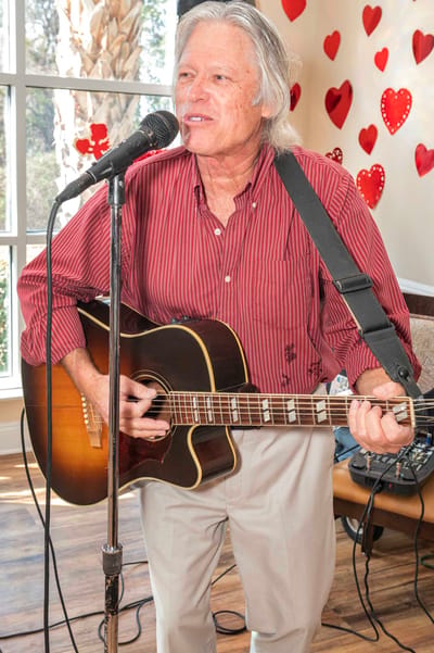 Musician performing for residents in a common area