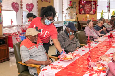 Residents celebrating Valentine's Day with treats in the common area