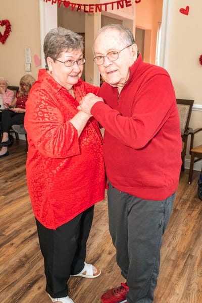 Residents dancing together in a cheerful activity room