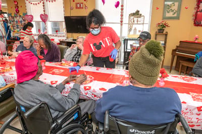 Residents enjoying a Valentine's Day celebration with activities and treats