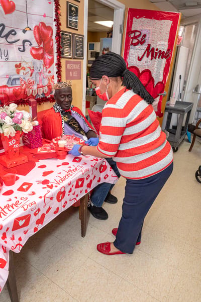 Resident celebrating Valentine's Day with staff