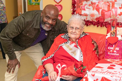 Resident celebrating Valentine's Day with staff