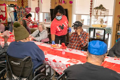 Residents enjoying a festive Valentine’s event with snacks