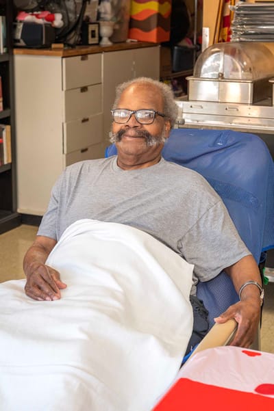 A resident smiling in an indoor setting
