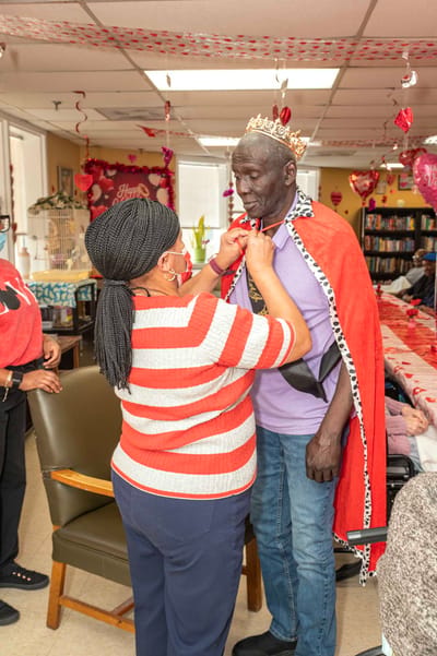 Staff member crowning a resident during a celebration
