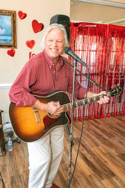 Musician performing at a celebration event with residents
