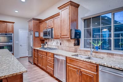 Modern kitchen interior with wooden cabinets and granite countertops
