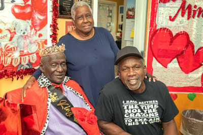 Residents celebrating with decorations and crowns