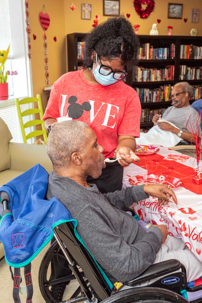 Staff member assisting resident during a celebration activity