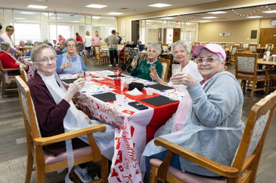 Residents enjoying a Valentine's Day activity in the dining room