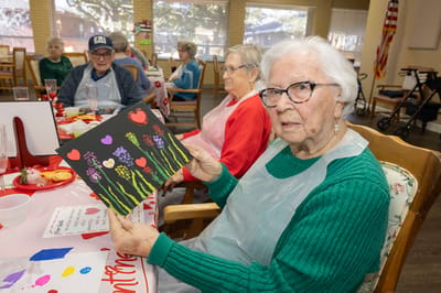 Residents participating in an art activity, displaying their work