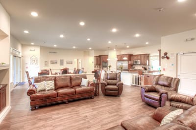 Common area with seating and kitchen in the background