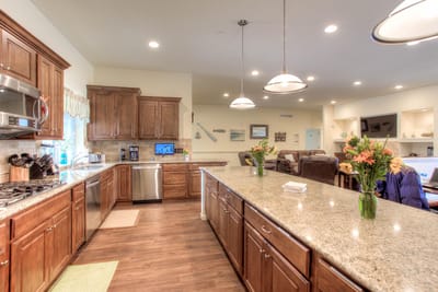 Interior of a kitchen area with wooden cabinets and flowers