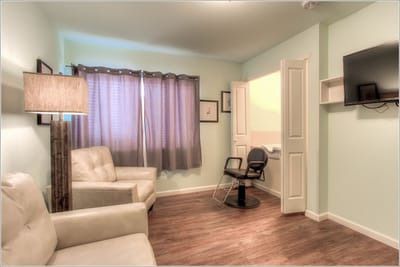 A bright interior view of a resident room with seating