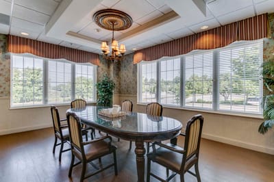 Bright common area with a dining table and chairs