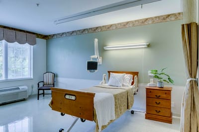 A private resident room with a hospital bed and decor