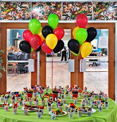 Celebration setup with colorful balloons and party supplies