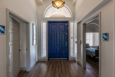 Welcoming entrance hallway with a blue front door.